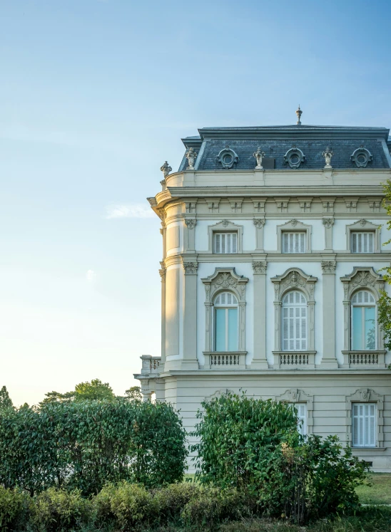 this white building has an ornate roof and two story