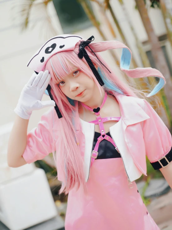 a woman dressed in pink holding a cat ears