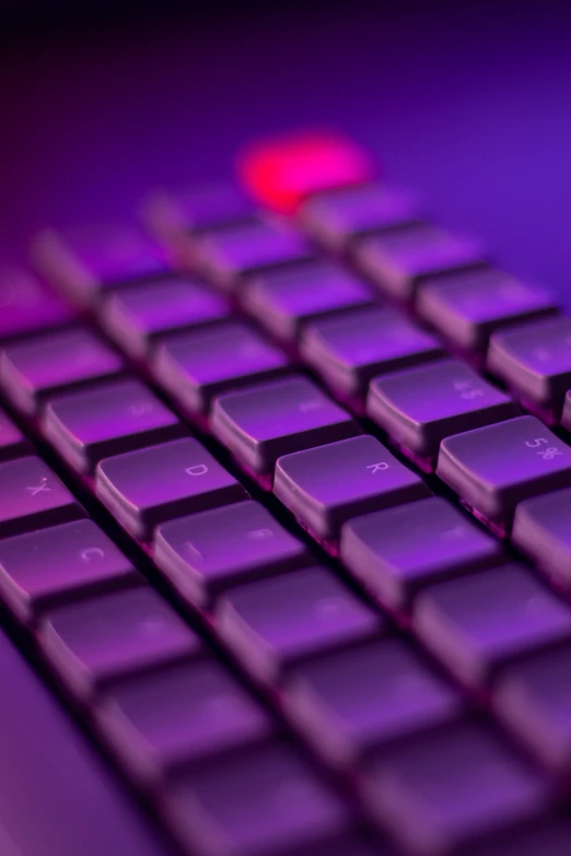 close up of a computer keyboard, with a lit red light