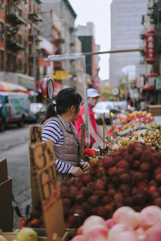 woman standing in front of an outdoor market area