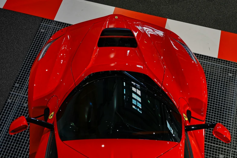 red sports car parked on black and white checkered floor