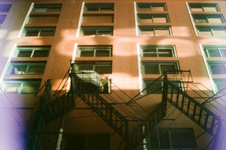 a tall building with an unusual staircase going up it