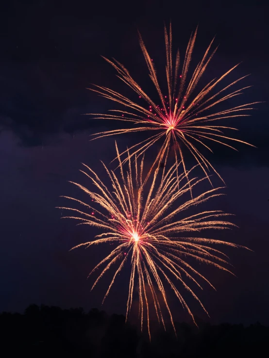 a large fireworks is lit up on the sky