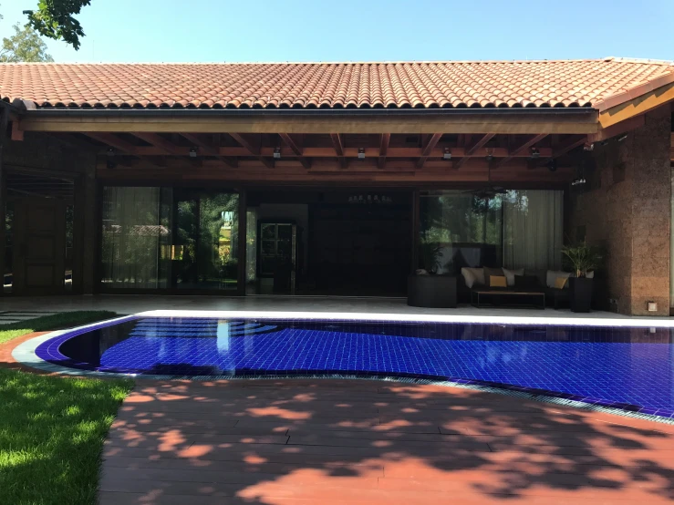 a blue pool in front of a house