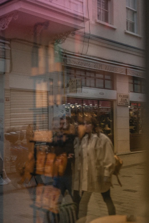 a blurred image of two people walking down the street