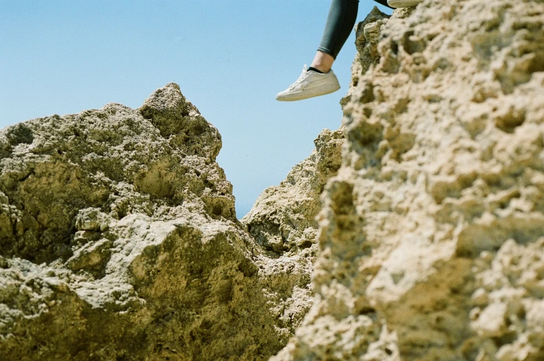 the person is sitting on top of the rocky hill