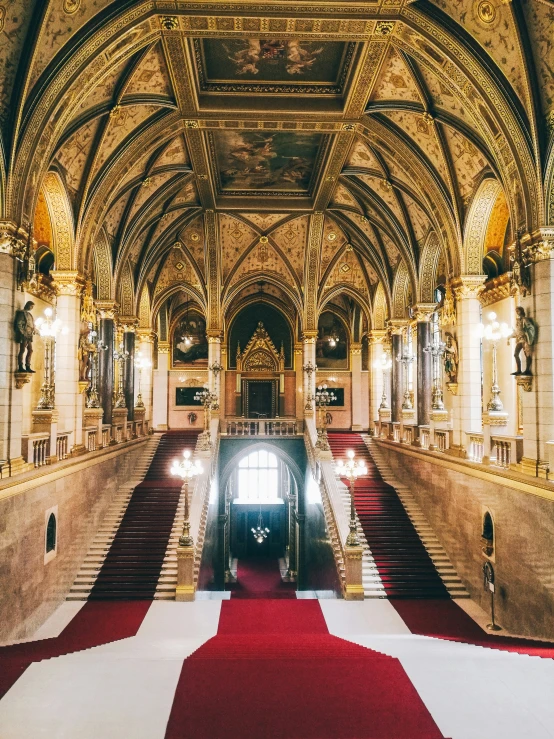 a very ornate, ornate looking room with stairs and chandeliers