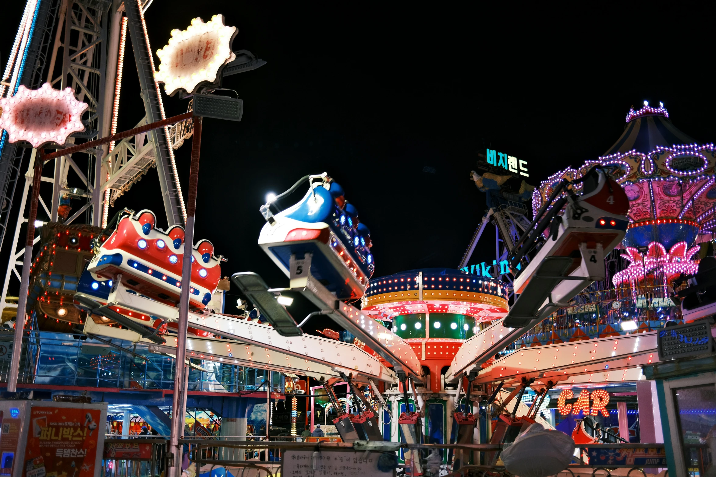 carnival rides with a sky lite in the background