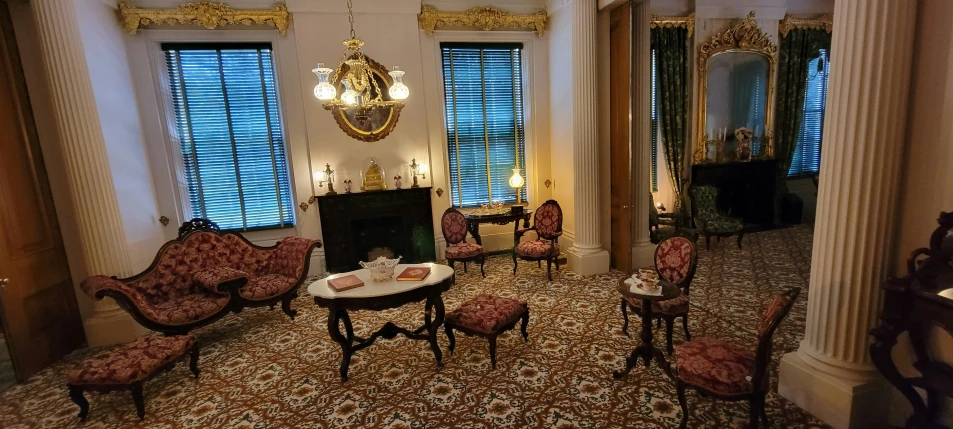 a large hall with an ornately decorated fireplace