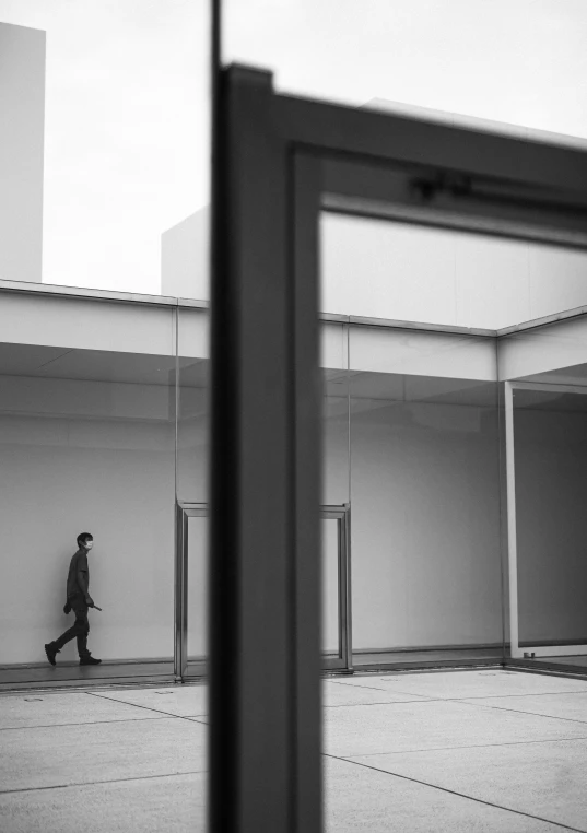 an old po of a man walking through a room