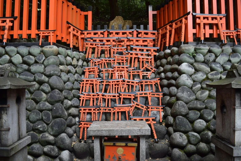 a group of orange chairs with rock walls