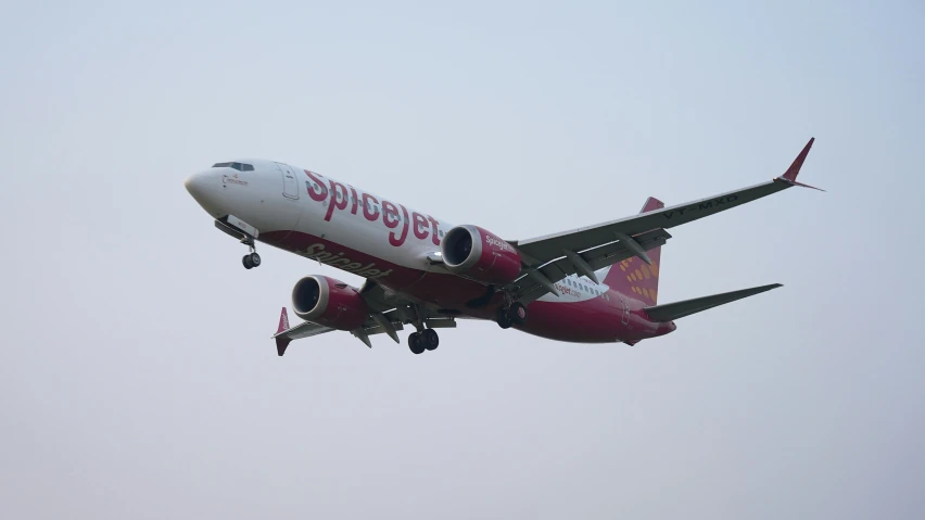 a large passenger jet flying through a cloudy sky