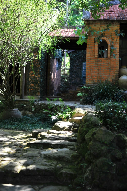 a path made of rock leading to a brick building