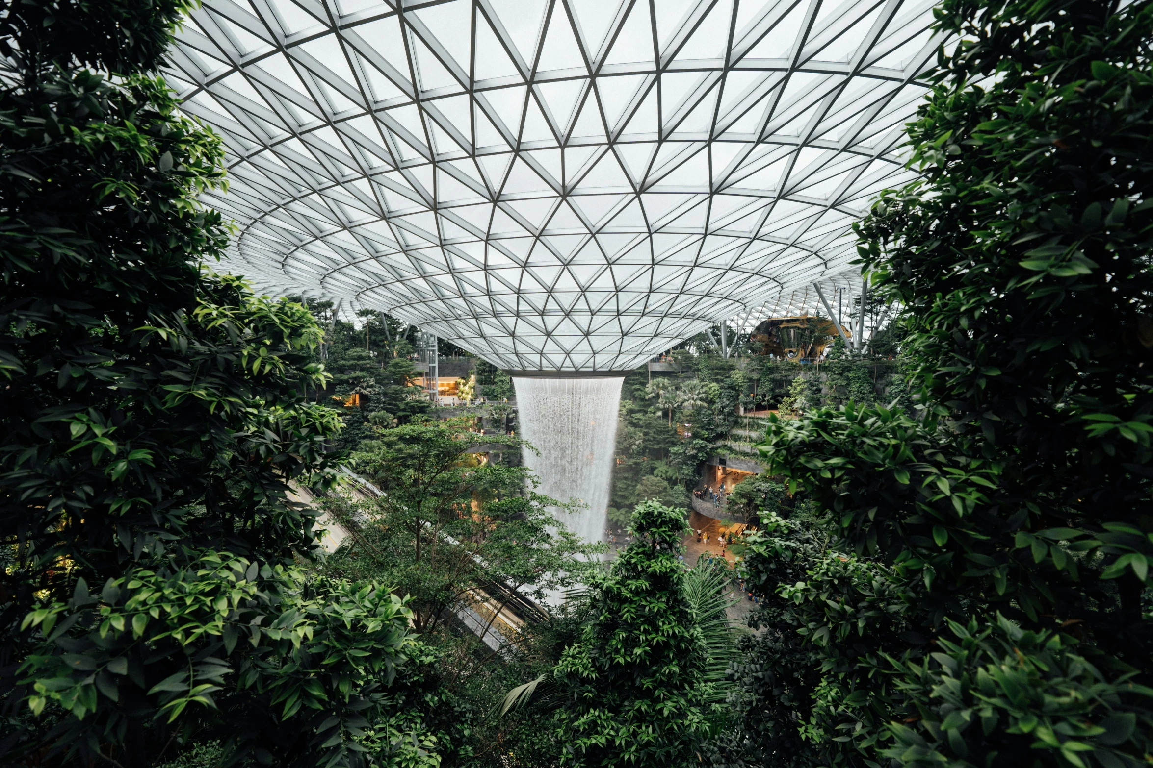 the interior of the building looking out at a waterfall