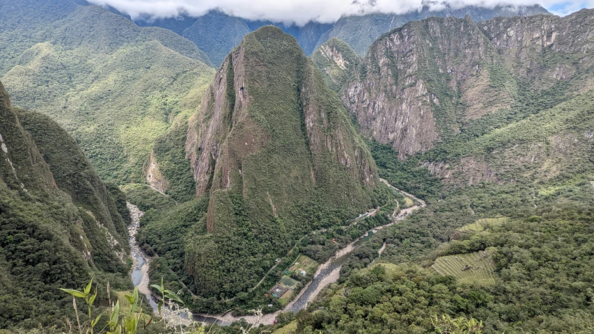 mountains are pictured above a valley in the foreground