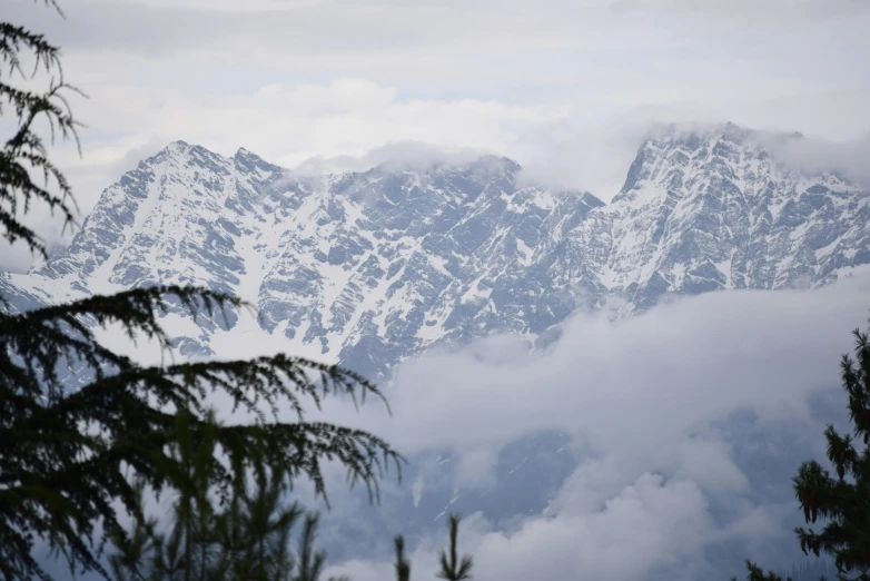 mountains covered in clouds and clouds in the distance