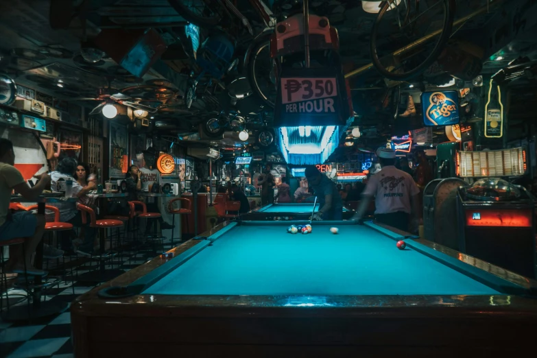 billiards are at tables inside of a pub