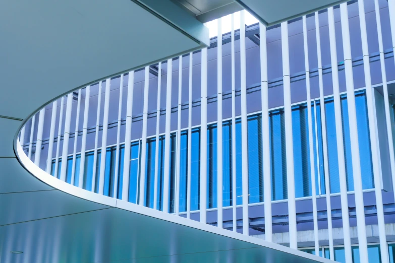 a close up of a long curved staircase next to a building