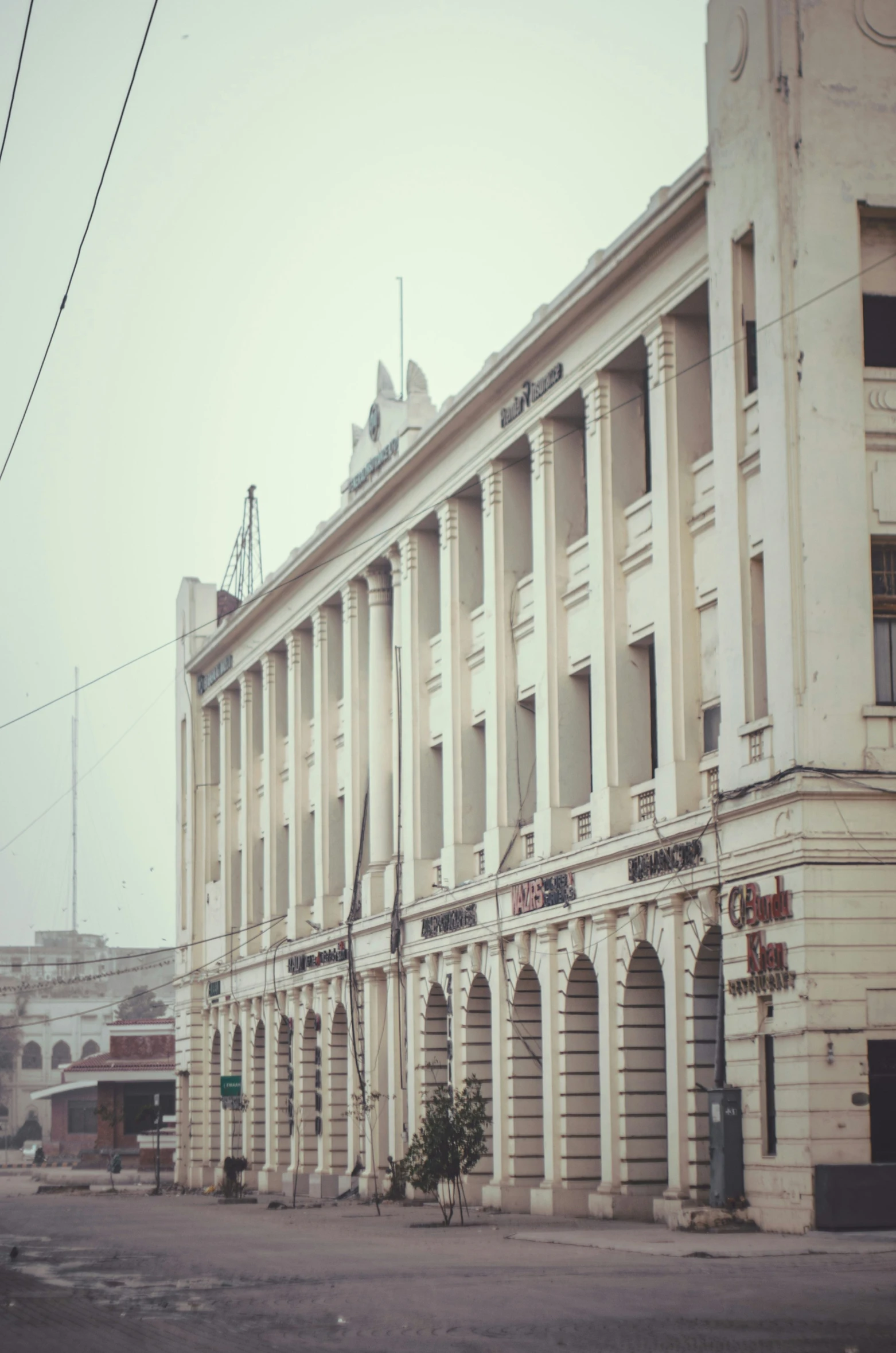 a large building sitting in front of an empty parking lot