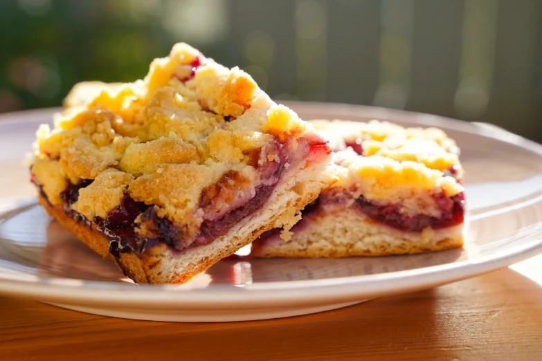 two desserts on a plate one has a crumb topping