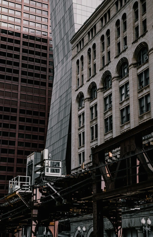 looking up at buildings in the background, with a train coming down the track