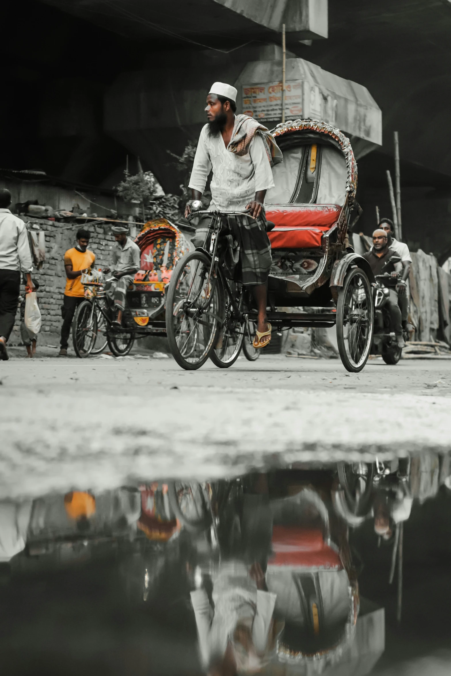 a man rides his bicycle beside a horse and buggy