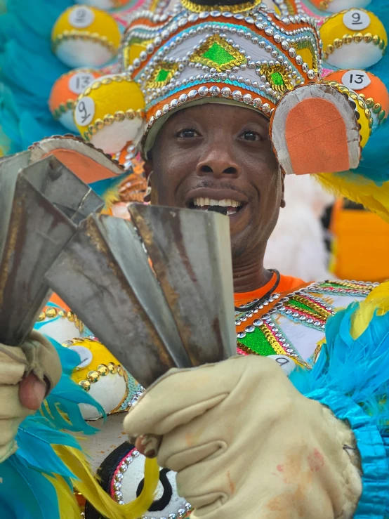 a man wearing a brightly colored headdress in a parade