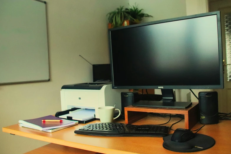 a computer monitor and keyboard on a desk