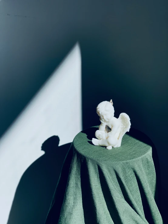 a teddy bear lying on top of a green towel