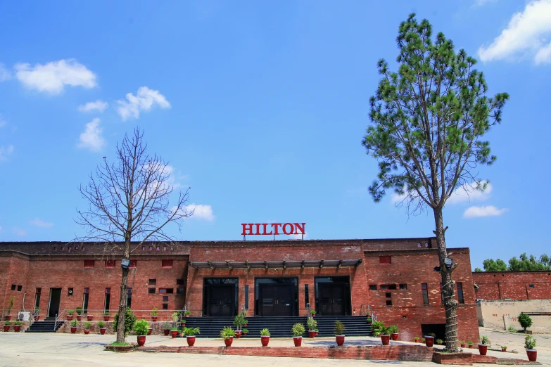 a red brick building with a sign that reads hilton on the top
