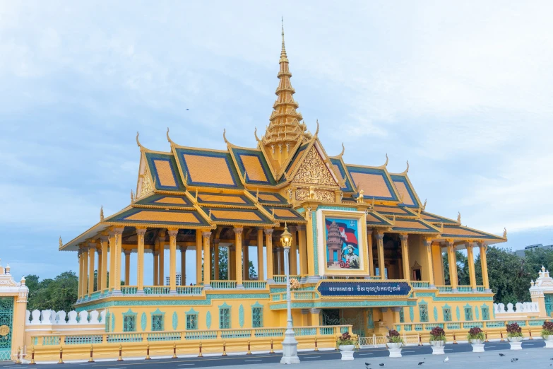 the yellow building with blue and gold details is located next to some other buildings