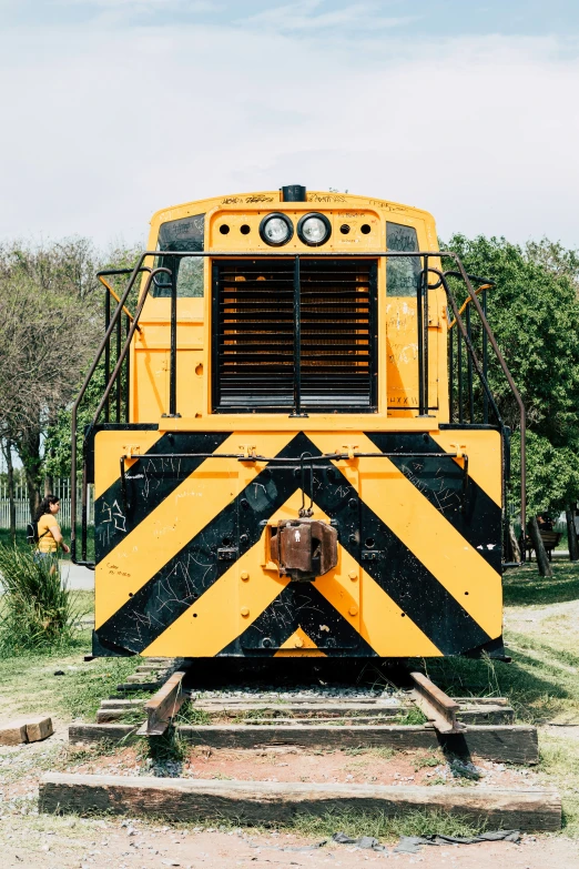 the train is yellow and black with stripes