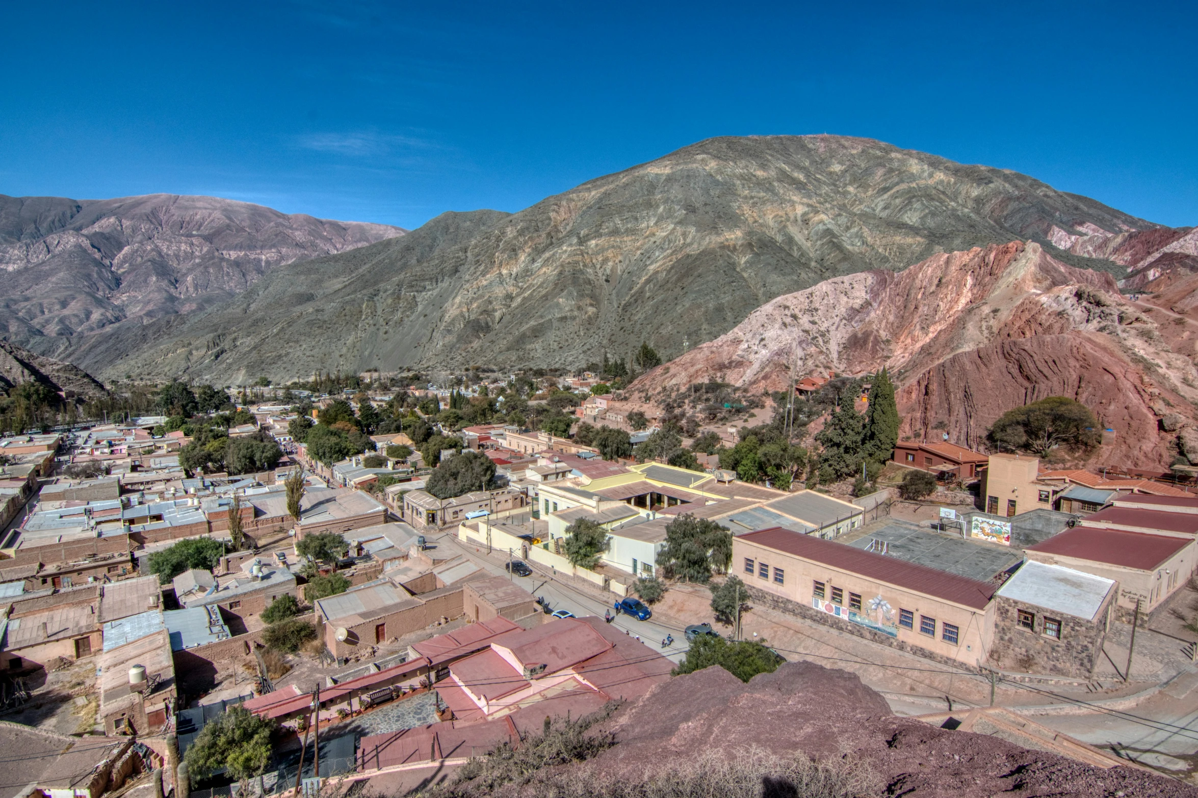 a view of some old town with mountains in the background