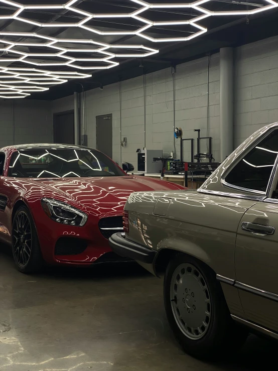 two mercedess parked inside a showroom under lights