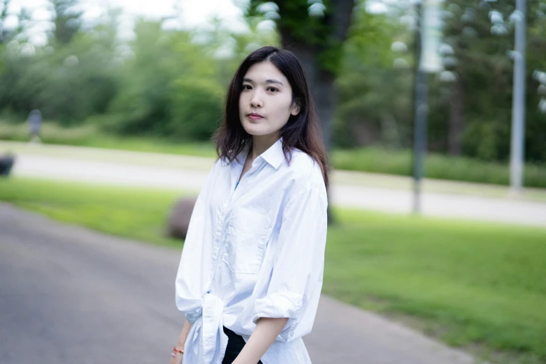 a woman standing by the side of a road