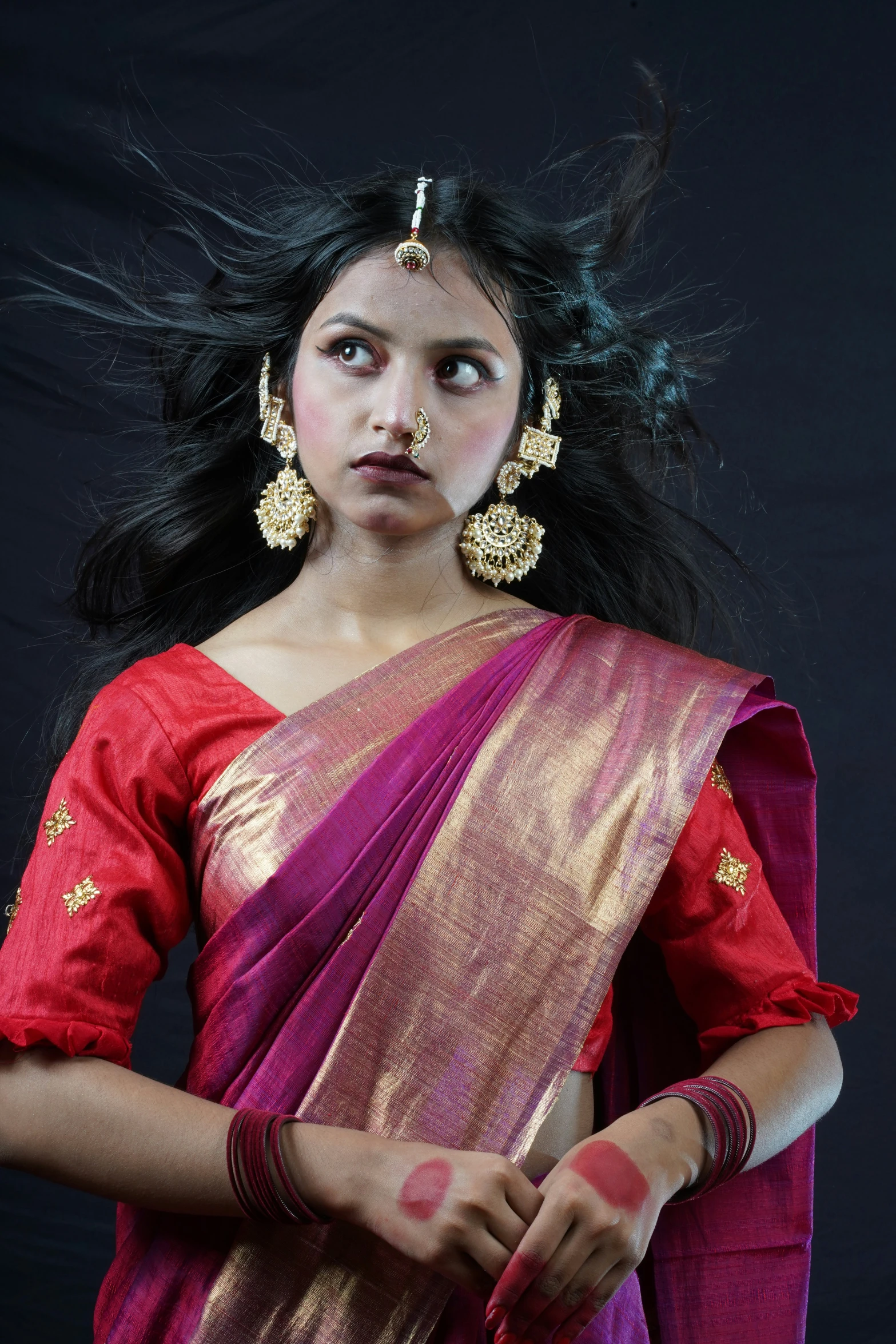 a very pretty lady in a pink and gold sari