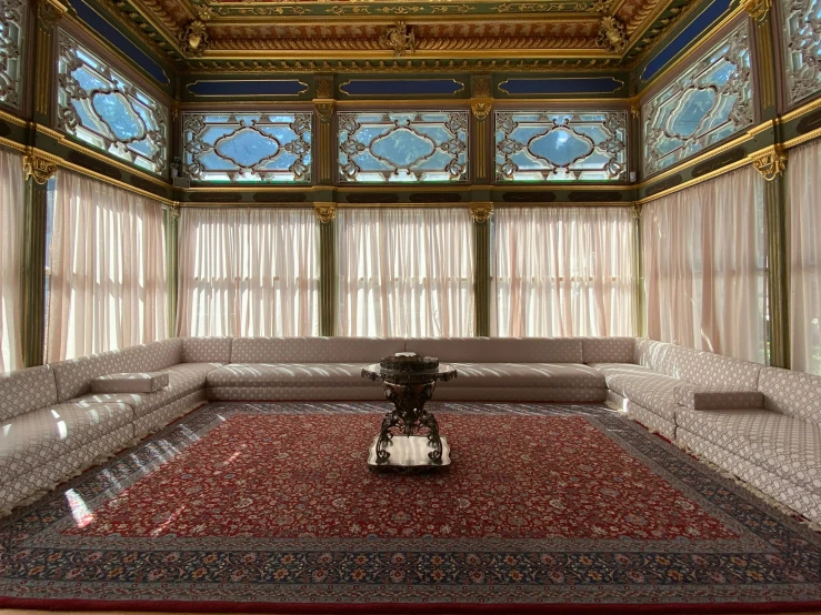 a white couch and table on top of a carpeted floor