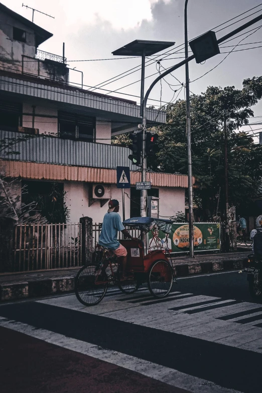 an old timey image of people on bicycles at a traffic light