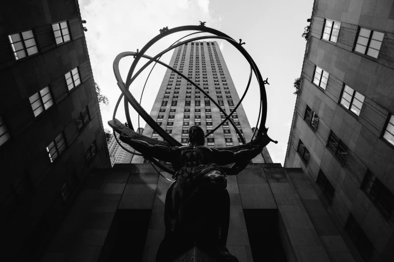 a statue is standing between two tall buildings