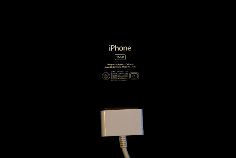 an iphone hooked up to a charging device