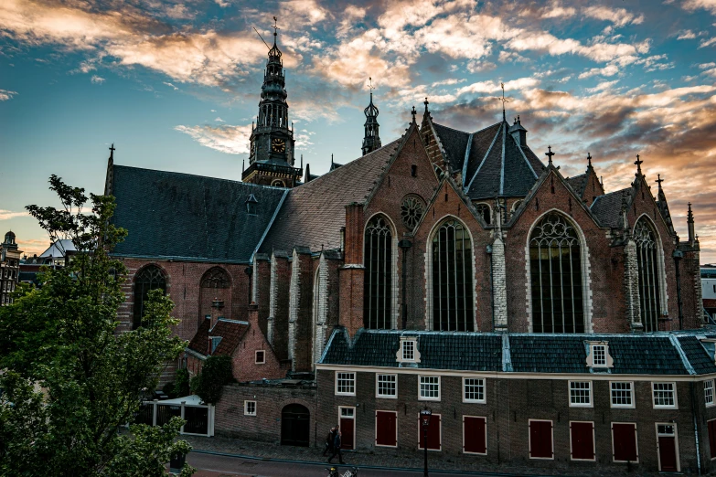 a gothic - looking church with many red windows against the sky