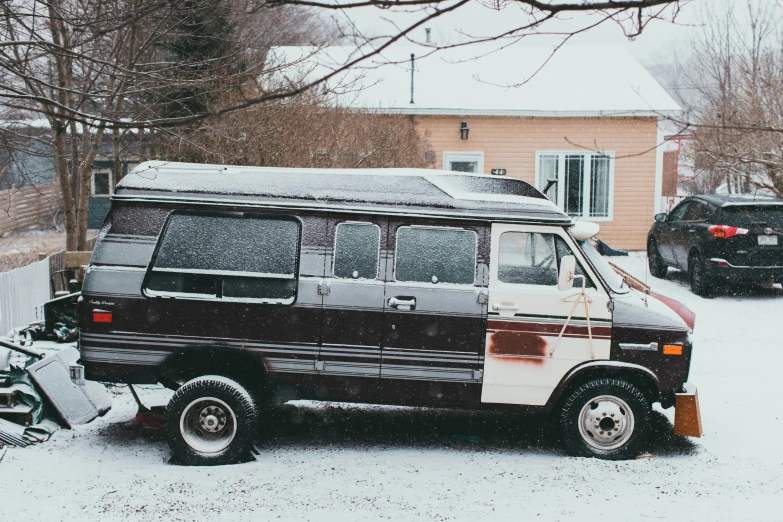 the vehicle is parked in a driveway covered with snow