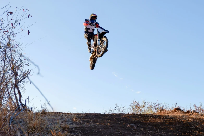 man on a dirt bike doing an aerial jump in the air