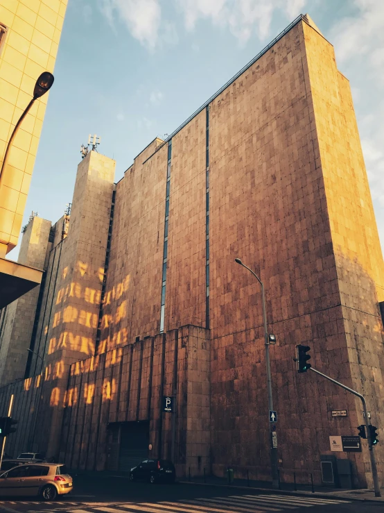 the side of a building is yellow against the blue sky