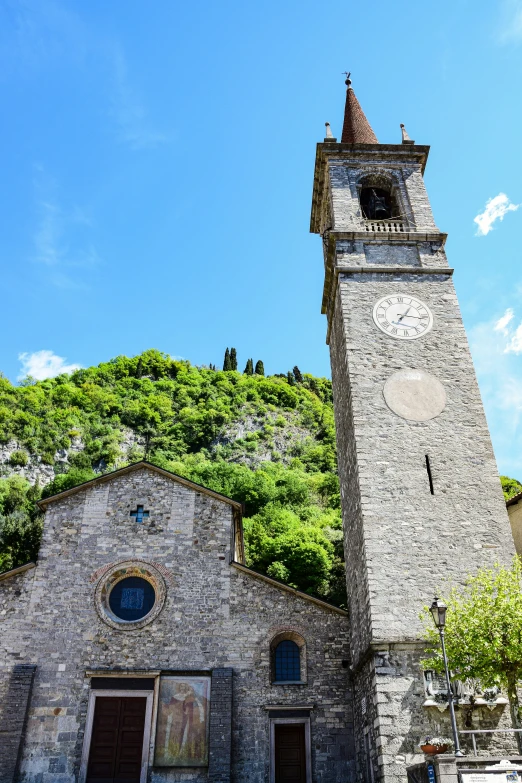 an old, large clock tower rises into the sky