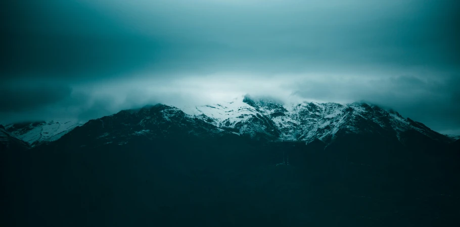 snow covered mountain range on an overcast day