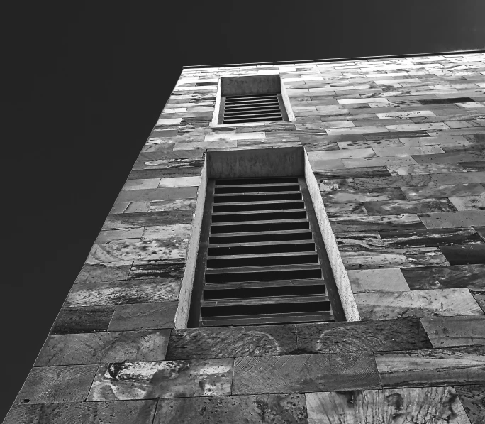 a window with a barred sill on top of a building