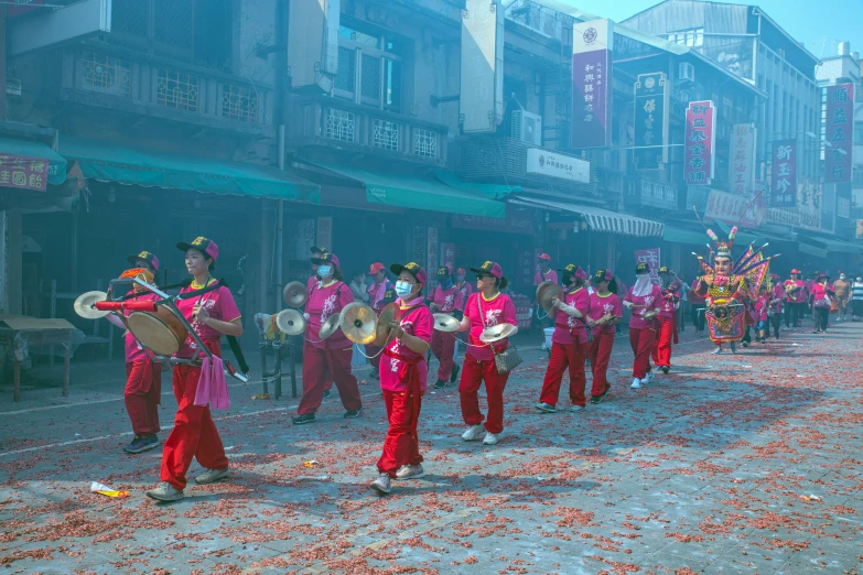 a group of people in red clothes are performing