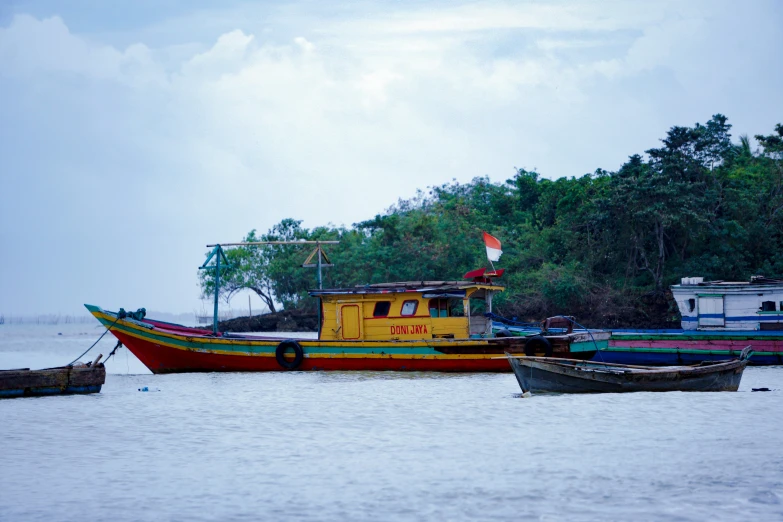 three small boats and two larger ones in the water