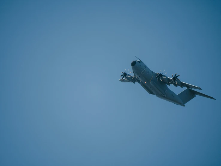 airplane in a clear blue sky flying at its peak